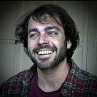 Darrell Beck AKA Dalton Kimbrough Smiling man with a dark beard and mustache